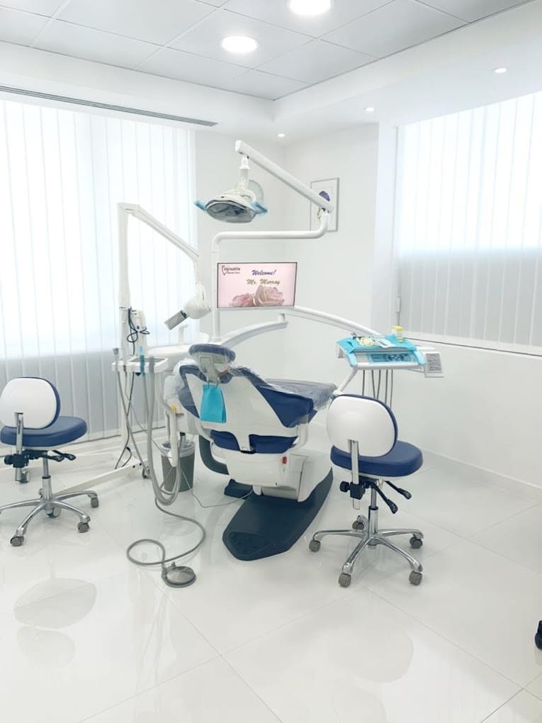 Modern dental operatory featuring a fully equipped treatment chair, LED overhead light, and ergonomic assistant stools. The room is clean, brightly lit, and designed for efficient patient care. Ideal setup for a dental practice in the UAE.