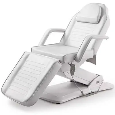 Modern white electric treatment chair with segmented upholstery and remote control.