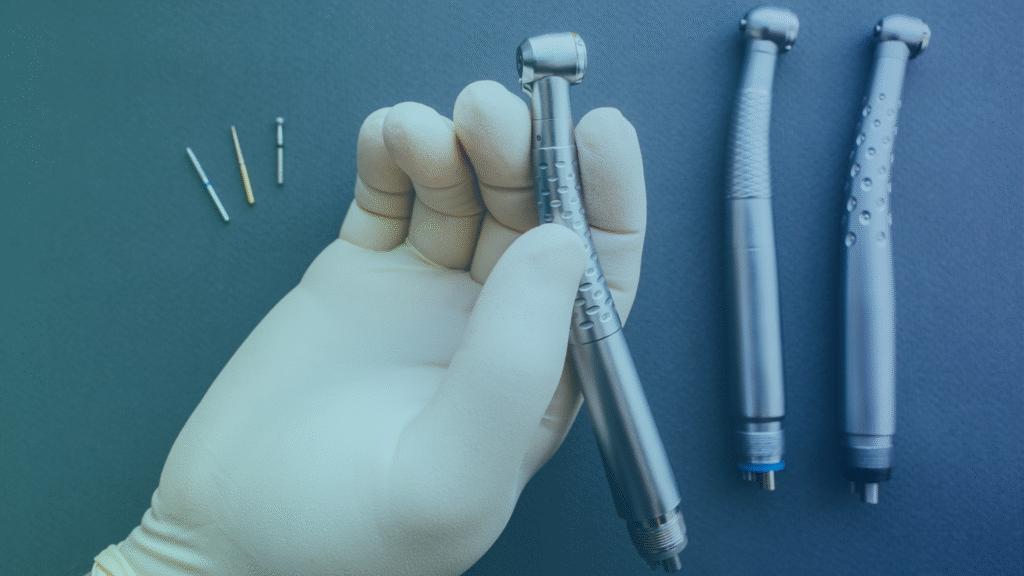 Dental handpieces and drills held by gloved hand: high-speed and low-speed turbines
